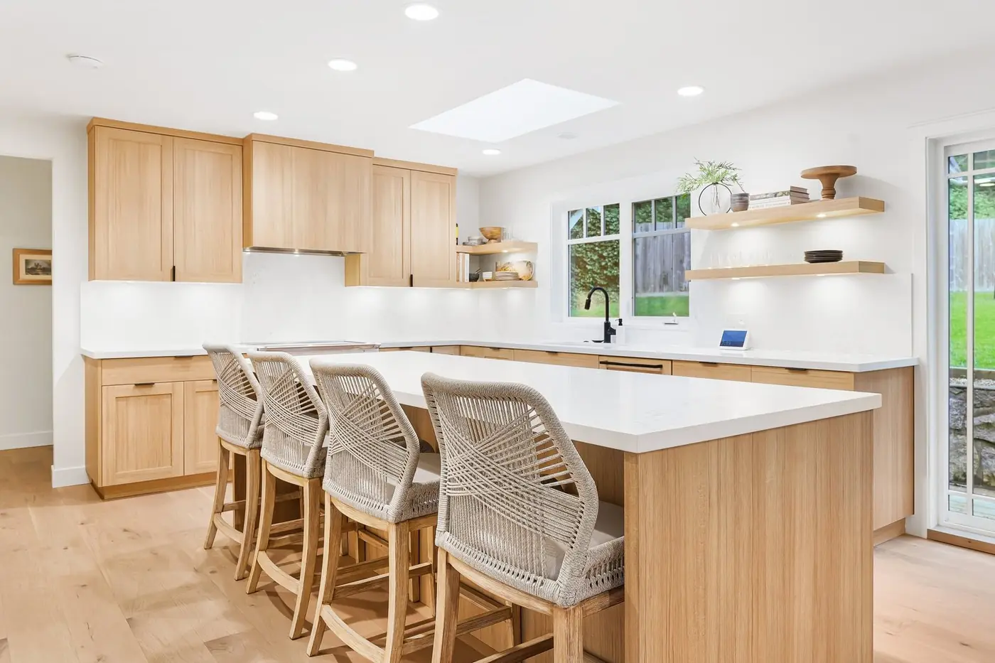 White-oak kitchen island with woven counter stools