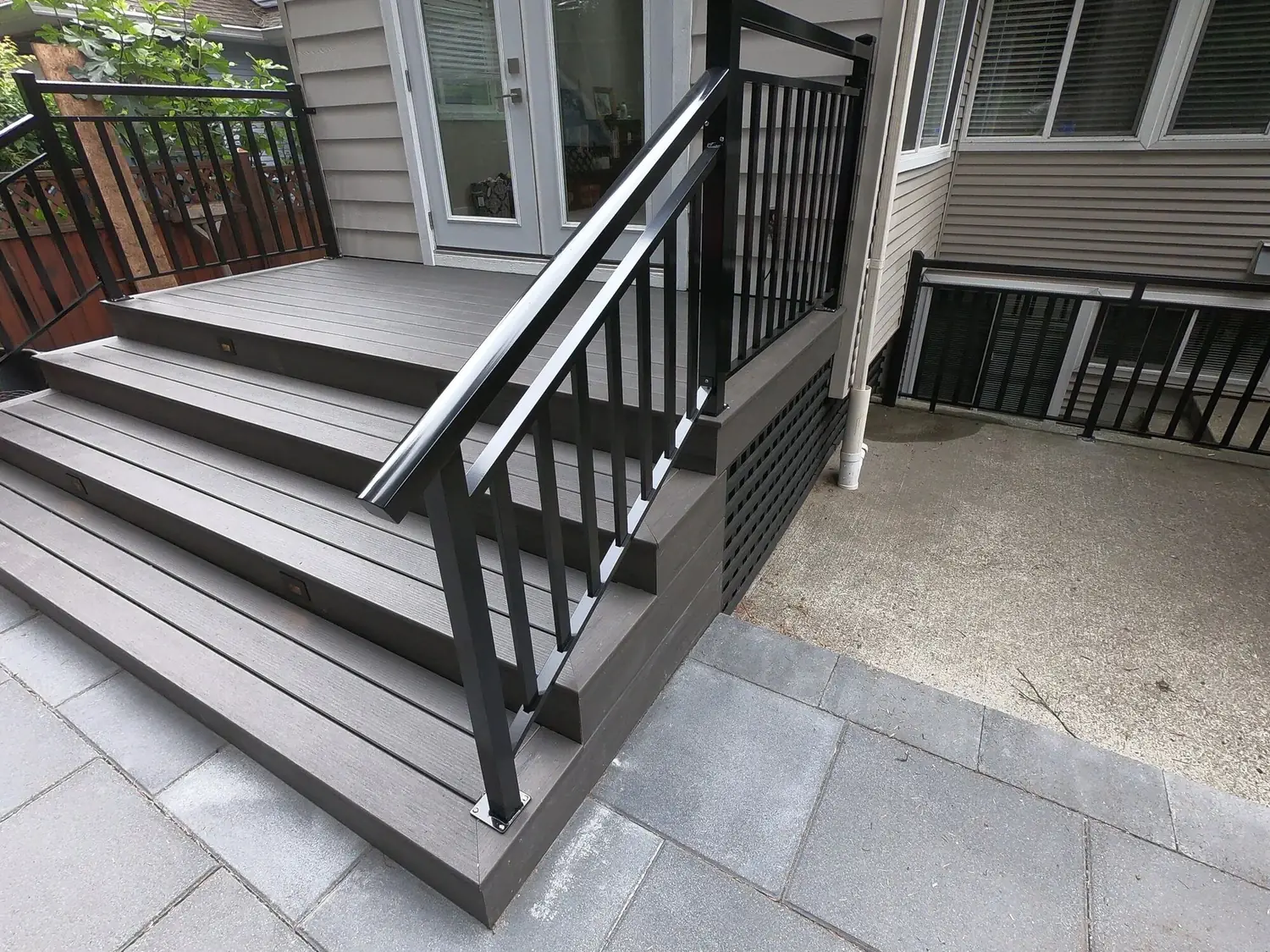 New composite deck stairs with black aluminum railings